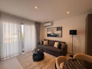 a living room with a couch and a table at Signature 1 Bedroom at The Bantree Accra in Accra