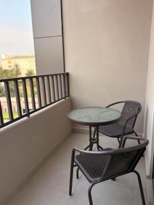 a table and two chairs on a balcony at Signature 1 Bedroom at The Bantree Accra in Accra
