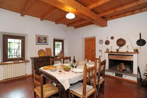 a dining room with a table and a fireplace at La casa dei Giardini, Bioglio in Bioglio