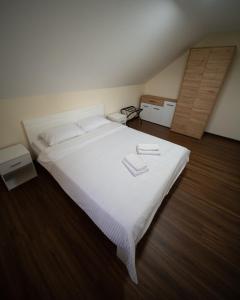 a bedroom with a large white bed with white sheets at Ilic House in Belgrade +10 photos