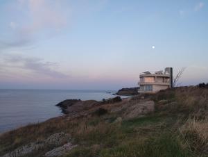 a building on a hill next to the ocean at Sea view in Sozopol