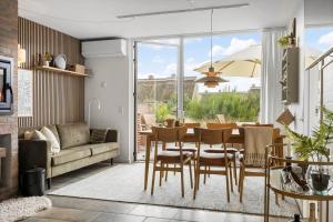 a living room with a table and chairs and a couch at 1900-Romo-Klitrosevej-40 in Sønderby