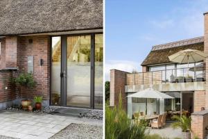 a house with glass doors and a patio with an umbrella at 1900-Romo-Klitrosevej-40 in Sønderby +17 photos