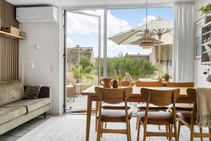 a dining room with a table and chairs and a couch at 1900-Romo-Klitrosevej-40 in Sønderby