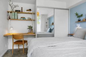 a bedroom with a bed and a desk and a mirror at 1900-Romo-Klitrosevej-40 in Sønderby