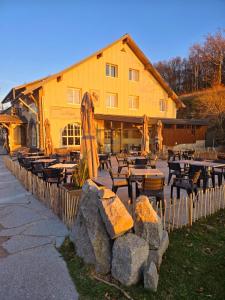 a restaurant with tables and umbrellas in front of a building at LA MAISON Crêperie-Bar-Hôtel in Le Valtin +62 photos