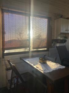 a kitchen with a table with a banana on it at Cabaña in Punta Del Diablo