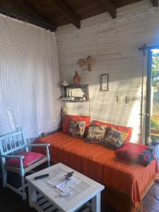 a living room with a bed and a table at Cabaña in Punta Del Diablo