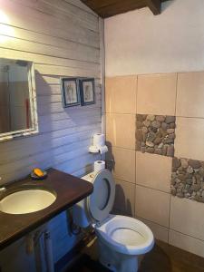 a bathroom with a toilet and a sink at Cabaña in Punta Del Diablo