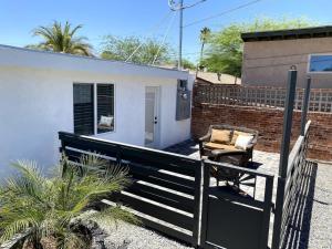 a house with a fence and a chair on a porch at E 1st Back Casita in Tucson