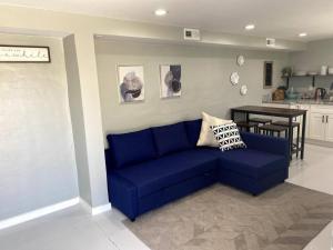 a blue couch in a living room with a kitchen at E 1st Back Casita in Tucson +9 photos