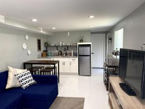 a living room with a blue couch and a kitchen at E 1st Back Casita in Tucson
