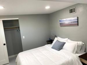 a bedroom with a white bed with a blue pillow at E 1st Back Casita in Tucson