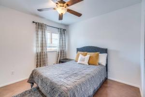 a bedroom with a bed and a ceiling fan at Parkway Terrace in Tucson +16 photos