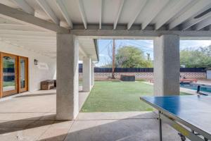 a patio with a ping pong table in a yard at Parkway Terrace in Tucson