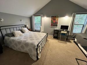 a bedroom with a bed and a desk with a computer at Leavenworth Mountain, Golf Course, 3br 4 ba in Leavenworth