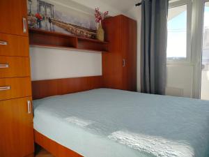 a small bedroom with a bed and a window at Udoban dvosoban stan 450 metara od mora in Boreti