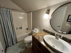 a bathroom with a sink and a toilet and a mirror at Leavenworth Mountain, Golf Course, 3br 4 ba in Leavenworth +17 photos