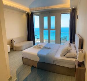 a bedroom with a bed with a view of the ocean at Alex inn Rooms in Alexandria +27 photos