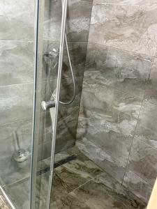a shower with a glass door in a bathroom at Yes apart hotel in Astana