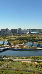 a large body of water with a city in the background at Yes apart hotel in Astana