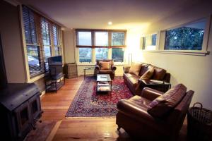a living room with two couches and a fireplace at Blue Wren Ridge in Buffalo River