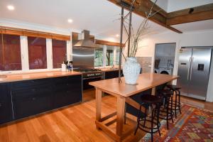 a kitchen with a wooden table with a vase on it at Blue Wren Ridge in Buffalo River