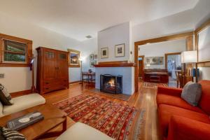 a living room with a fireplace and a red couch at N 1st Ave in Tucson