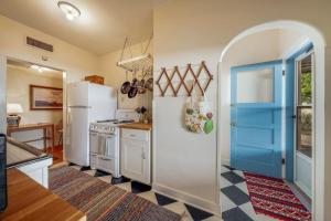 a kitchen with a white refrigerator and a blue door at Casita #7 in Tucson