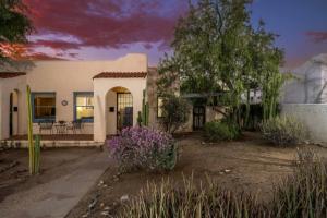 a house with a yard with flowers in front of it at Casita #7 in Tucson