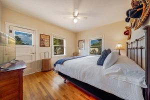 a bedroom with a bed and two windows at Casita #7 in Tucson