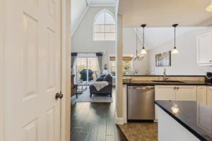 a kitchen with a door open to a living room at 225 Snowbridge with Village Shuttle in Collingwood