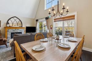 a dining room and living room with a table and chairs at 225 Snowbridge with Village Shuttle in Collingwood