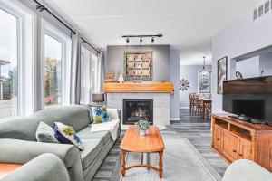 a living room with a couch and a fireplace at 2BDR Condo Steps to Blue Mountain Village - 101 Cachet Crossing in Blue Mountains