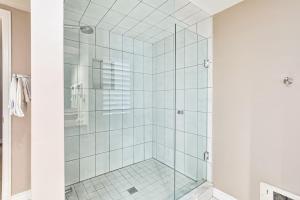 a shower with glass doors in a bathroom at 2BDR Condo Steps to Blue Mountain Village - 101 Cachet Crossing in Blue Mountains +18 photos