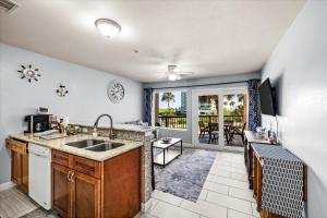 a kitchen with a sink and a counter top at Seashell Retreat - Beachfront Condo with Pools and Cabanas in Galveston