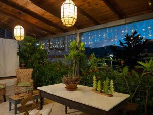 a patio with a table with plants and lights at Villa Clara - Comfort e natura nel cuore di Sambuca in Sambuca di Sicilia