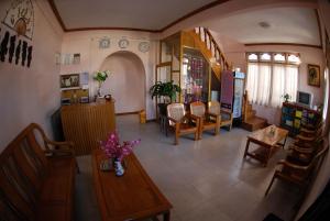 a living room with a table and some chairs at Gypsy Inn in Nyaung Shwe