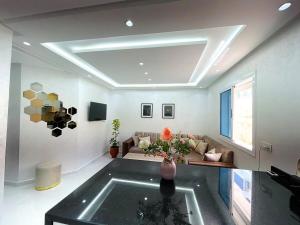 una sala de estar con un sofá y una mesa en Luxurious condo with patio and terrace, en Alhucemas