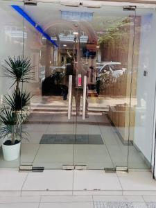 a glass door of a store with a table in it at Elite Hotel KL Sentral in Kuala Lumpur +10 photos