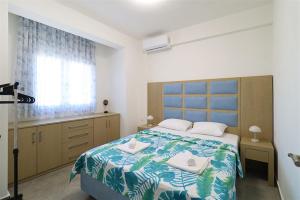 a bedroom with a bed with two towels on it at Breeze Apartment Nikiti in Nikiti