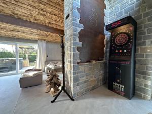 a room with a dart board in a brick wall at Chez Brigitte in Durbuy