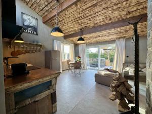 a kitchen and living room with wooden walls at Chez Brigitte in Durbuy