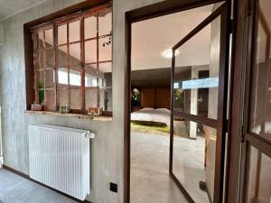 an open door to a room with a bedroom at Chez Brigitte in Durbuy +29 photos