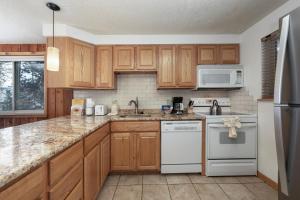 a kitchen with wooden cabinets and white appliances at Beaver Village Unit #0724 in Winter Park
