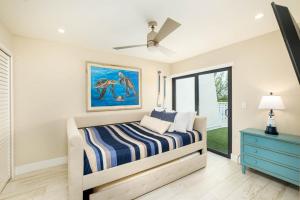 a bedroom with a bed and a painting on the wall at Beautiful Key Largo Escape Pool, Tennis & Marina in Key Largo +54 photos