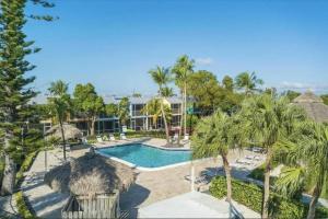an aerial view of a resort with a swimming pool at Beautiful Key Largo Escape Pool, Tennis & Marina in Key Largo