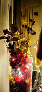 a vase with christmas lights and flowers in it at Stella del Garda in Lazise