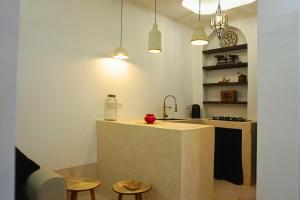 a kitchen with a counter and two stools and a sink at Little date in Marrakech +28 photos