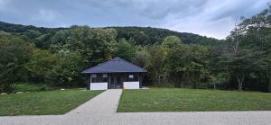a small building in the middle of a field at Golden Spa Villa in Bihać